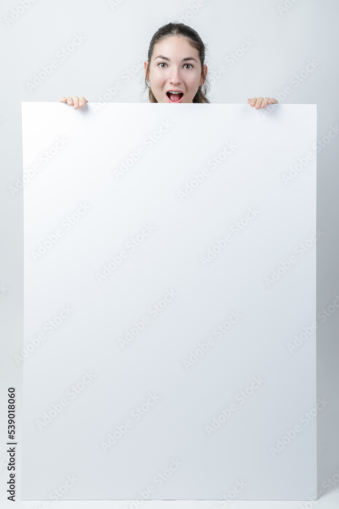 Young woman holding a blank white sign - Banner Mockup. Young woman holding a blank white sign - Banner Mockup.
