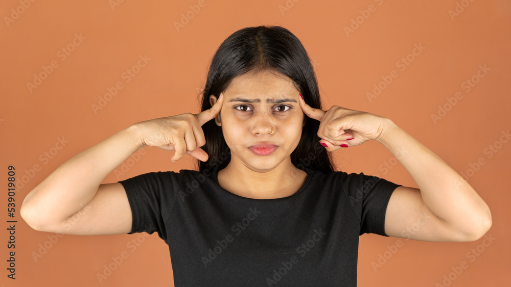 Fototapeta premium Portrait of a stressed woman on color background, sad depressed young girl isolated