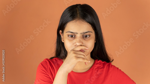 Portrait of a stressed woman on color background, sad depressed young girl isolated