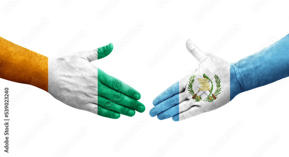 Handshake between Guatemala and Ivory Coast flags painted on hands, isolated transparent image. Handshake between Guatemala and Ivory Coast flags painted on hands, isolated transparent image.