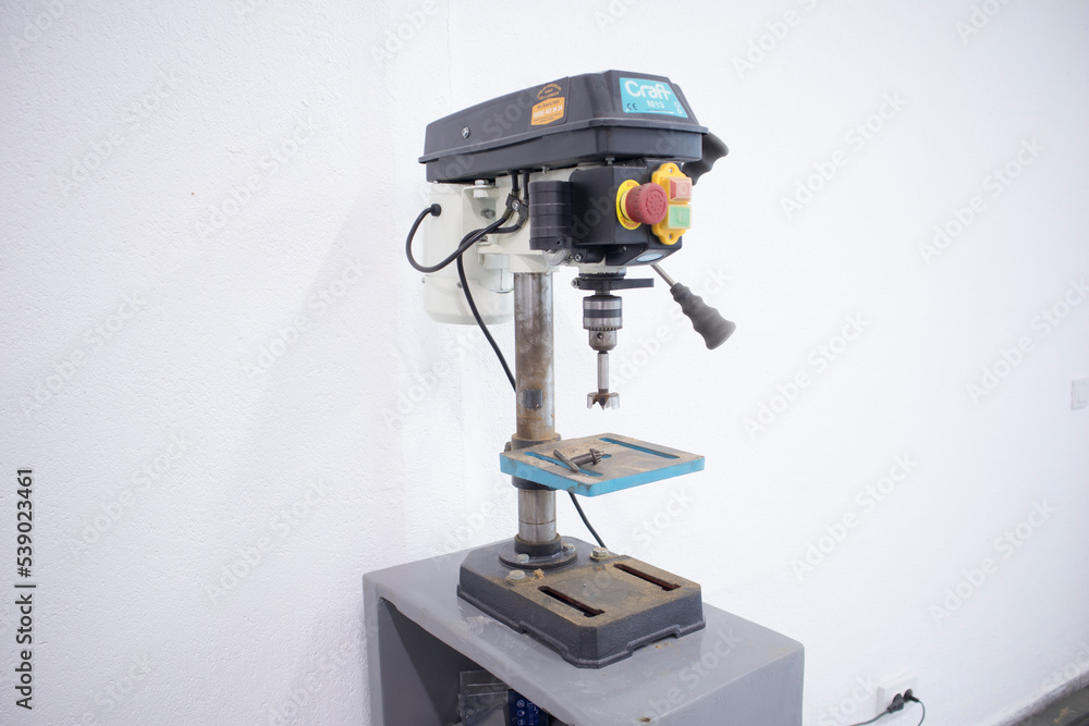 vertical drill stand and on off switches mounted on the table top vertical drill stand and on off switches mounted on the table top