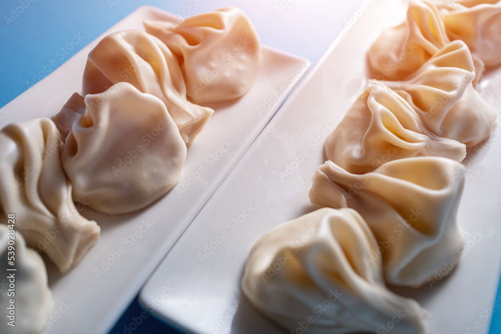 traditional georgian khinkali dumplings with cheese or meat on blue background traditional georgian khinkali dumplings with cheese or meat on blue background