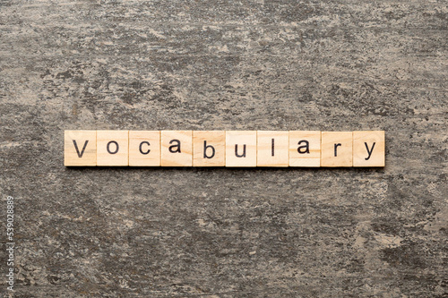vocabulary word written on wood block. vocabulary text on table, concept photo