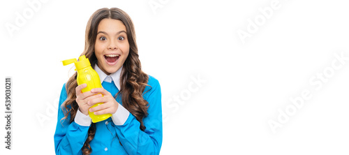 Happy child hold yellow plastic bottle with dairy food isolated on white, yogurt. Horizontal poster of isolated child face, banner header, copy space.