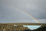 A rainbow over the waters of the Blue Lagoon, a geothermal spa in Iceland. Image has copy space.