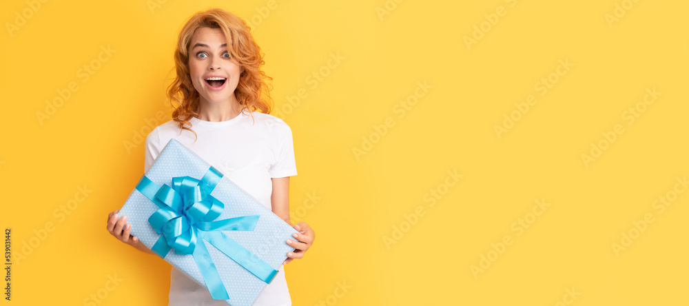 surprised redhead lady with giftbox. womens day. Beauty woman isolated face portrait, banner with mock up copy space.
