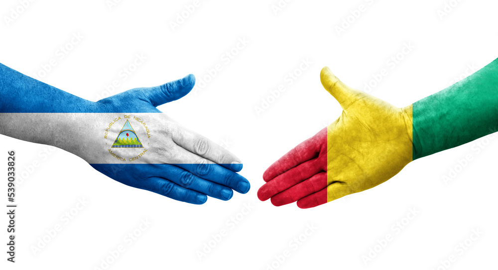 Handshake between Guinea and Nicaragua flags painted on hands, isolated transparent image. Handshake between Guinea and Nicaragua flags painted on hands, isolated transparent image.