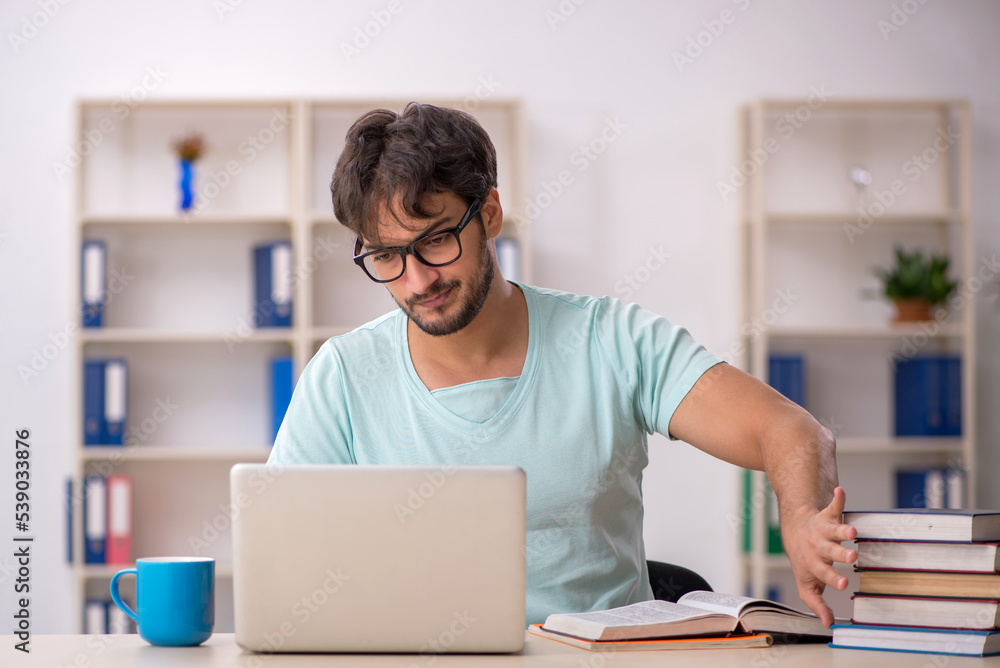 Young male student preparing for exams in the classroom Young male student preparing for exams in the classroom