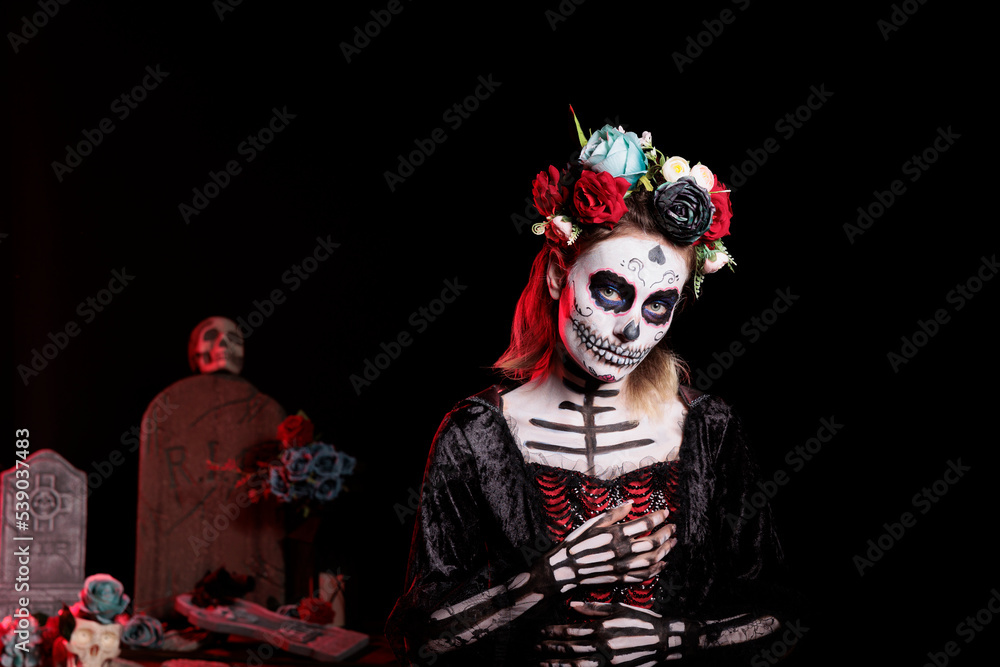 Creepy goddess of death with festival make up and halloween costume to celebrate dios de los muertos mexican holiday. Spooky woman as santa muerte with flowers crown, day of the dead. Creepy goddess of death with festival make up and halloween costume to celebrate dios de los muertos mexican holiday. Spooky woman as santa muerte with flowers crown, day of the dead.