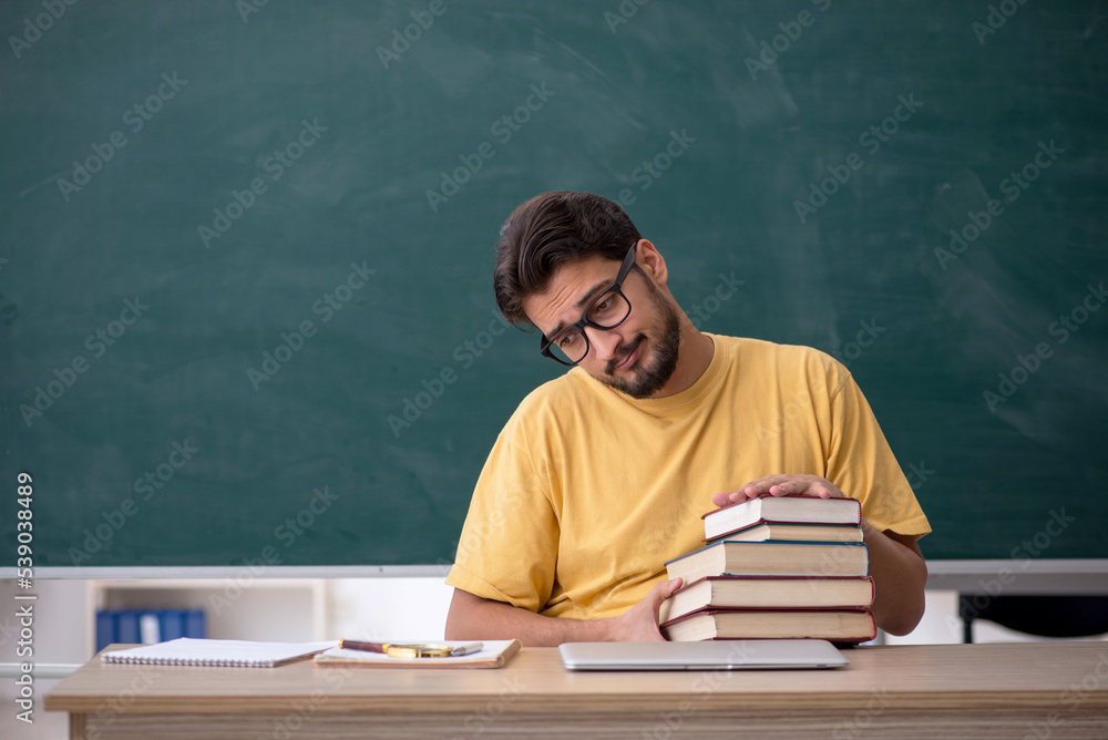 Young male student preparing for exams in the classroom Young male student preparing for exams in the classroom