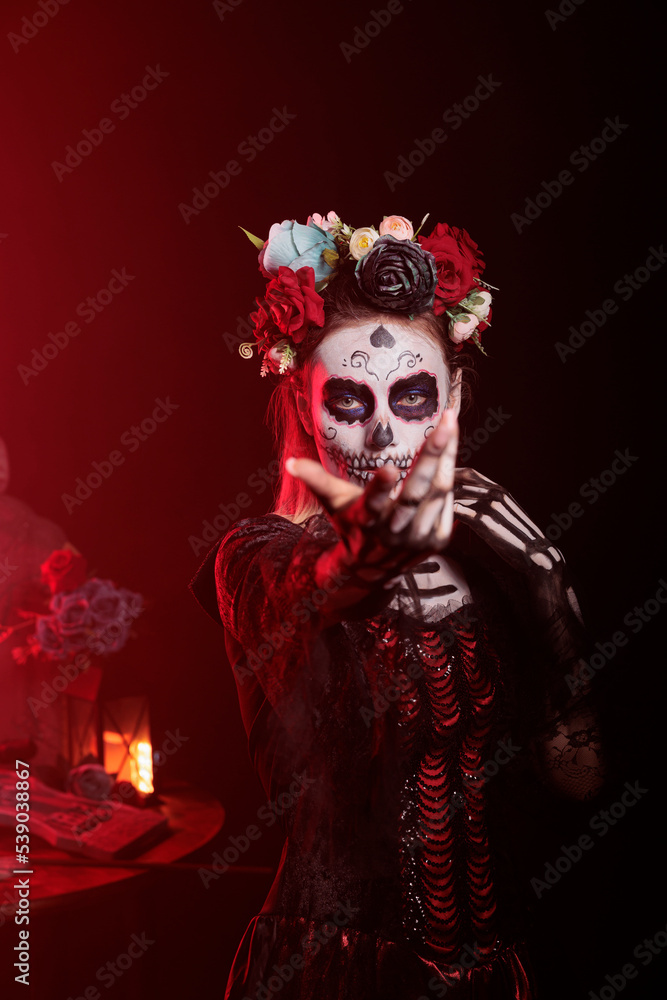 Flirty goddess of death tempting and luring victims, looking like la cavalera catrina with skull make up and body art. Santa muerte costume on mexican halloween horror celebration. Flirty goddess of death tempting and luring victims, looking like la cavalera catrina with skull make up and body art. Santa muerte costume on mexican halloween horror celebration.