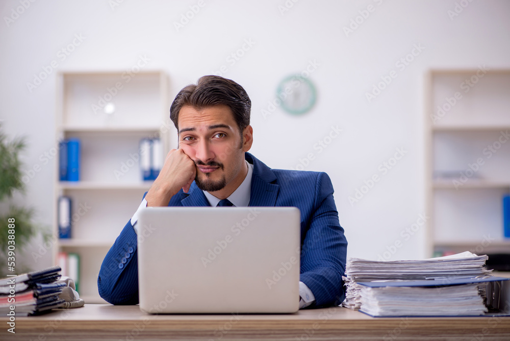 Young male employee working in the office Young male employee working in the office