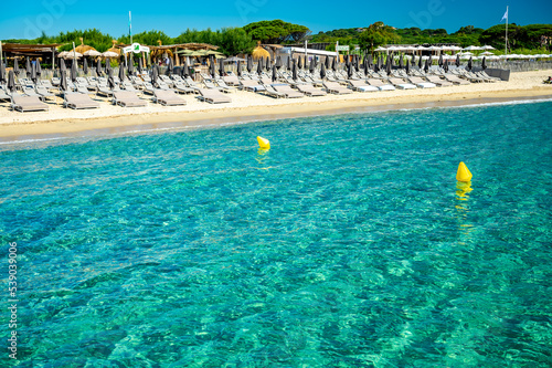 Crystal clear blue water of legendary Pampelonne beach near Saint-Tropez  summer vacation on white sandy beaches of French Riviera  France