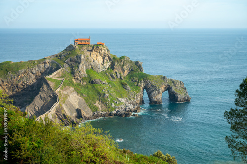 Stone footpath to famous landmark and film location in North of Spain, ocean islet with chapel San juan de gaztelugatxe, Basque Country, Spain