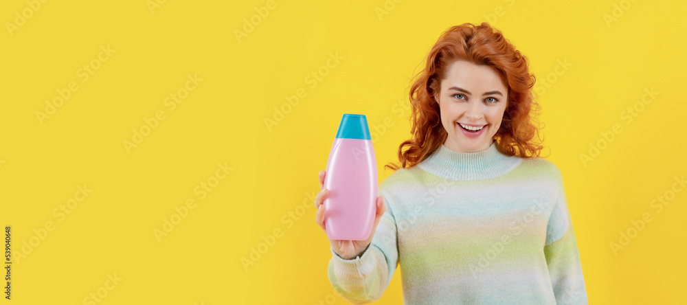 Woman isolated face portrait, banner with copy space. happy redhead woman with shampoo bottle. shampooing hair in salon. girl with hair conditioner. Woman isolated face portrait, banner with copy space. happy redhead woman with shampoo bottle. shampooing hair in salon. girl with hair conditioner.