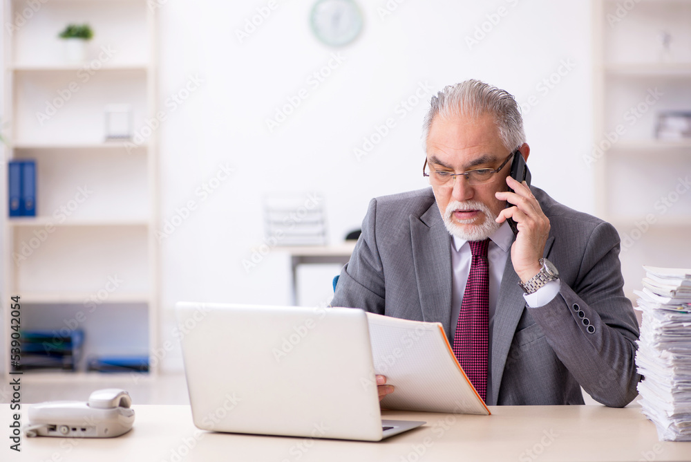 Old male employee and too much work in the office Old male employee and too much work in the office