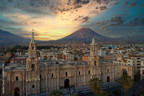 Aerial view of the Plaza de Armas with the Arequipa Cathedral and the Misti Volcano in the background in Arequipa, Peru at the blue hour/sunset. photo
