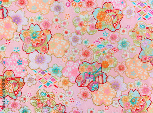 Tableau sur toile Closeup detailed photograph of a traditional Japanese furoshiki made in cotton with a pastel pattern of cherry, plum or peony flowers adorned with butterfly, temari balls,aristocracy's bullock cart