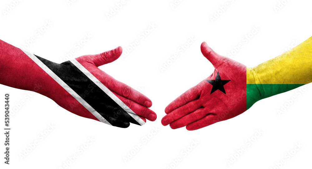 Obraz premium Handshake between Guinea Bissau and Trinidad Tobago flags painted on hands, isolated transparent image.