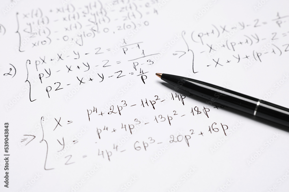 Sheet of paper with mathematical formulas and pen, closeup Sheet of paper with mathematical formulas and pen, closeup