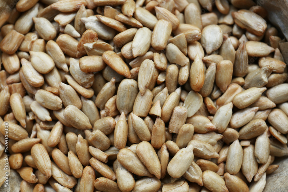 Pile of peeled sunflower seeds as background, closeup Pile of peeled sunflower seeds as background, closeup