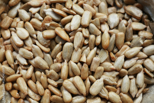 Pile of peeled sunflower seeds as background, closeup