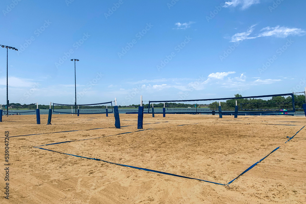 Several sand beach with beach volleyball courts near the lake, zone for active rest on the bank of the river. Concept of summer sport, activity on open air.