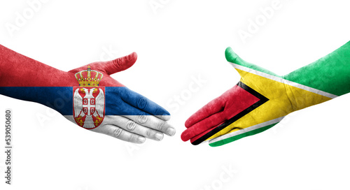 Handshake between Guyana and Serbia flags painted on hands, isolated transparent image.