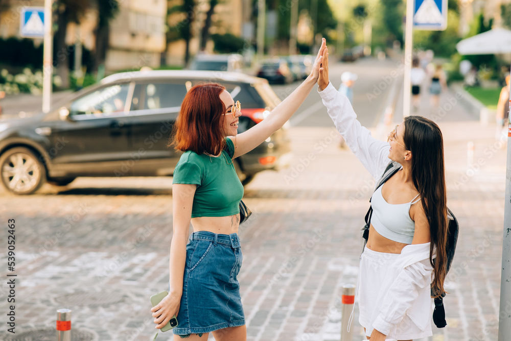 Two students high five to teach others after successful work together