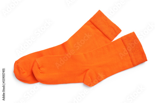 Pair of orange socks on white background, top view