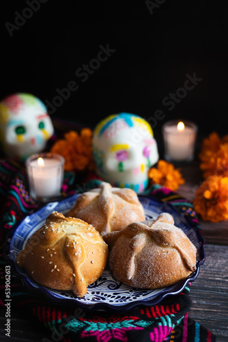 Hojaldra pan de muerto, Mexican bread on Altar with sugar skull and hot chocolate traditional food for Celebration of Mexico's Day of the Dead 