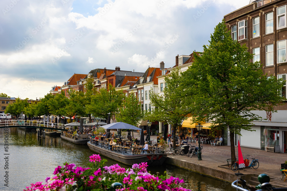 Obraz premium Picturesque view of houses, streets and canals at Leiden town at summer day, Netherlands