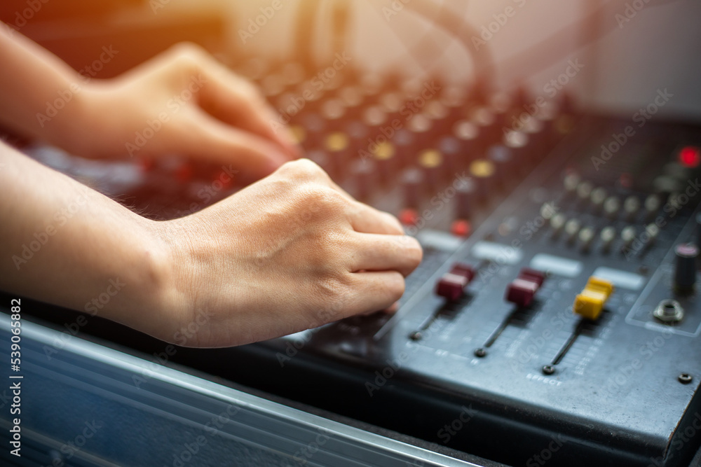 close up hands tuning of sound mixer