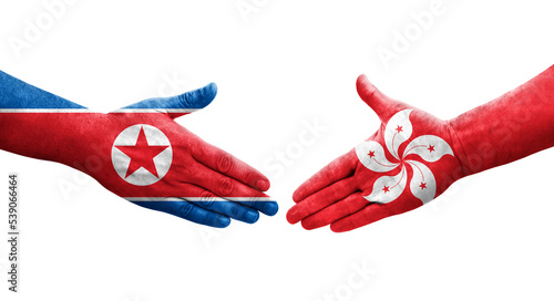 Handshake between Hong Kong and North Korea flags painted on hands, isolated transparent image.
