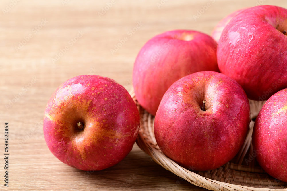 Red apple fruit in basket on wooden background, Healthy fruit