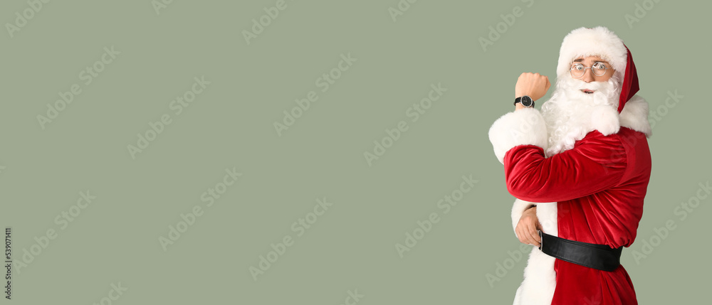 Man in Santa costume and with watch on color background with space for text. Christmas countdown concept Man in Santa costume and with watch on color background with space for text. Christmas countdown concept