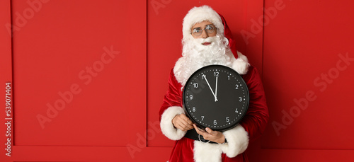 Santa Claus holding clock o...