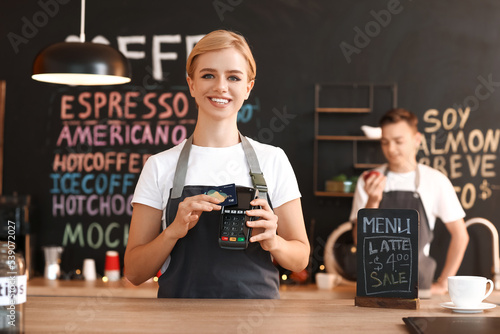 Young female barista with c...