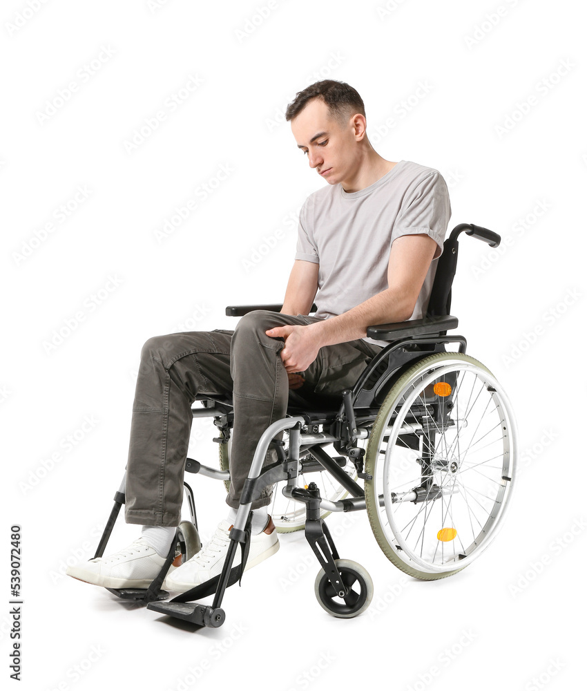 Young man in wheelchair isolated on white Young man in wheelchair isolated on white