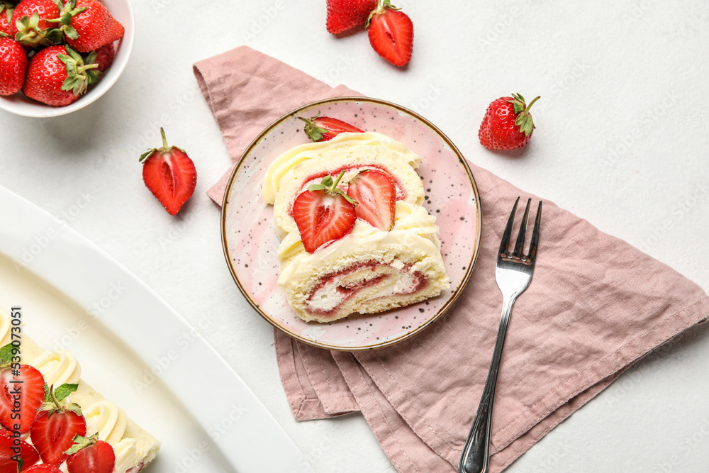 Plate with slices of tasty strawberry roll cake on light background Plate with slices of tasty strawberry roll cake on light background