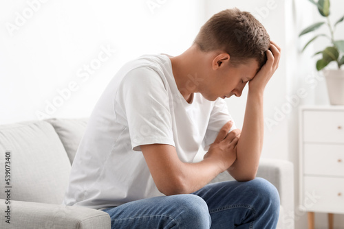 Stressed young man sitting ...