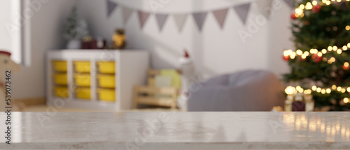 Fotografija Empty mockup space on tabletop over blurred kid's playroom decorated in Christma