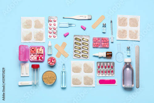 Mustard plasters with medicines on blue background