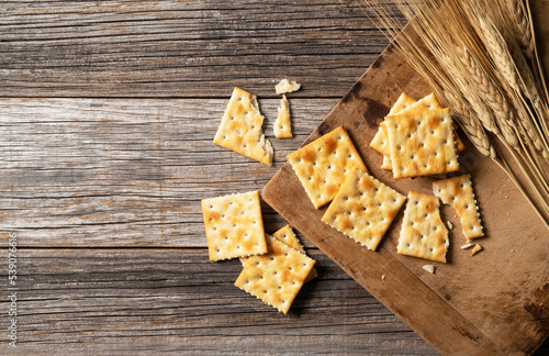 Cracker placed against old wooden background. photo