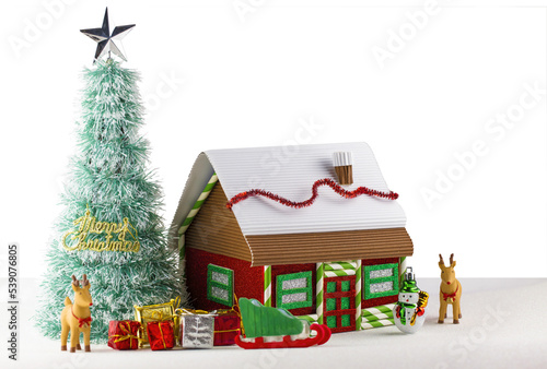 Kids school craft handmade decorated Christmas house with Christmas tree and ornaments  photo