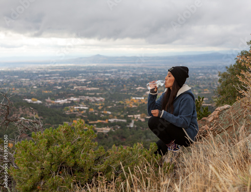 Woman drinking water on summit