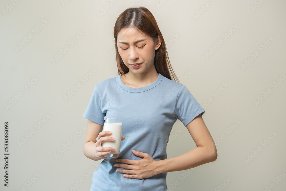 Pain, suffering asian young woman having a stomachache, abdominal pain