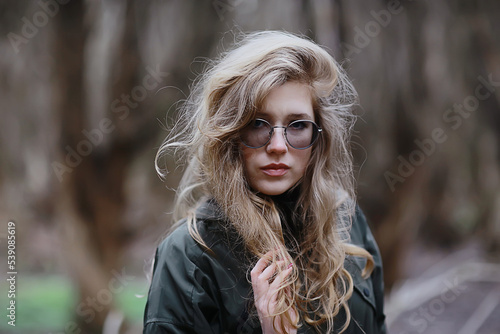 gloomy autumn park girl portrait, unusual toning autumn look model