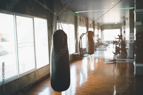 Foto Punch bag at fitness center club with training exercise boxing sandbag
