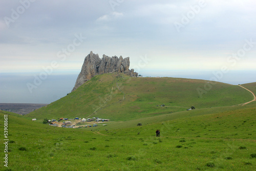 Pilgrims climb Mount Beshbarmag.